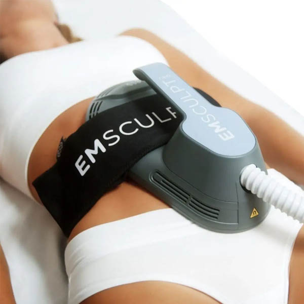 EMSculpt applicators positioned over the abdomen during a Glasgow treatment