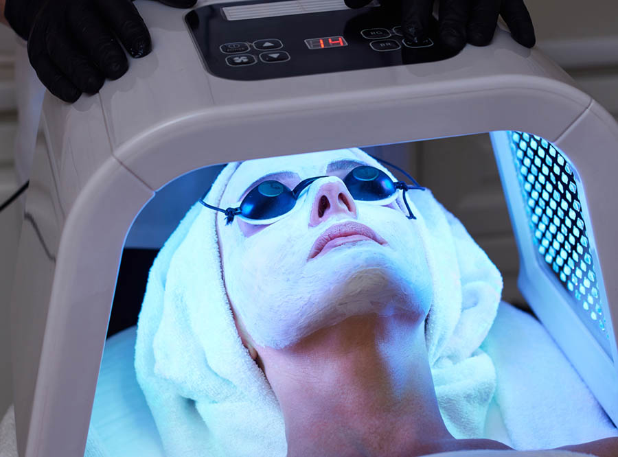 Client under an LED facial array at VIVO Glasgow